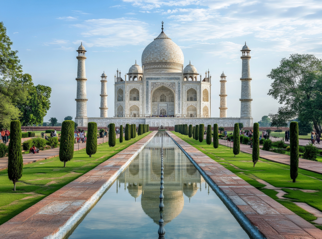 White marble Taj Mahal reflected in water at sunrise, India