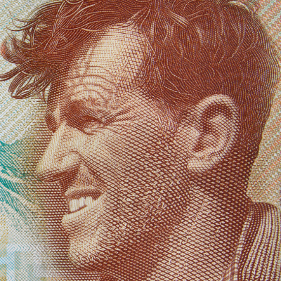 Close-up of Sir Edmund Hillary's portrait on the New Zealand five-dollar banknote, featuring Aoraki / Mount Cook in the background. Early Explorers Page