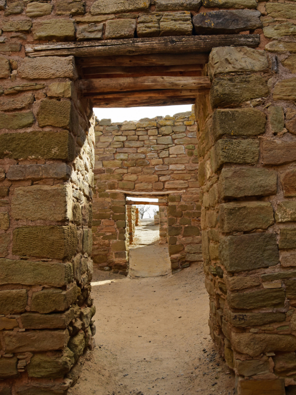 "A series of ancient stone doorways or passages within a Puebloan great house, part of the ruins at either Aztec Ruins National Monument or Chaco Culture National Historical Park, showcasing the monumental architecture of the ancestral Pueblo people."