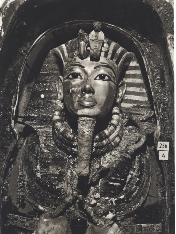 A 1922 black-and-white photograph of Tutankhamun’s burial mask, taken by Harry Burton during the excavation of the King Tut Sarcophagus. The mask, made of gold and inlaid with lapis lazuli and other precious stones, is one of ancient Egypt’s most iconic artifacts.
