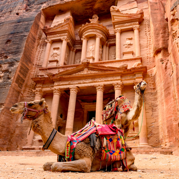 The narrow Siq canyon leading to Petra’s Treasury, Jordan, with carved rock walls.