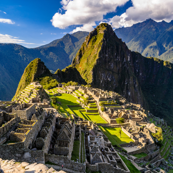 Machu Picchu's ancient Inca stone structures nestled among Andean peaks at sunrise. Countries that start with P.