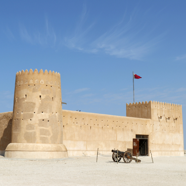 Qatar's desert landscape meeting the Persian Gulf coastline. Countries that start  with Q.