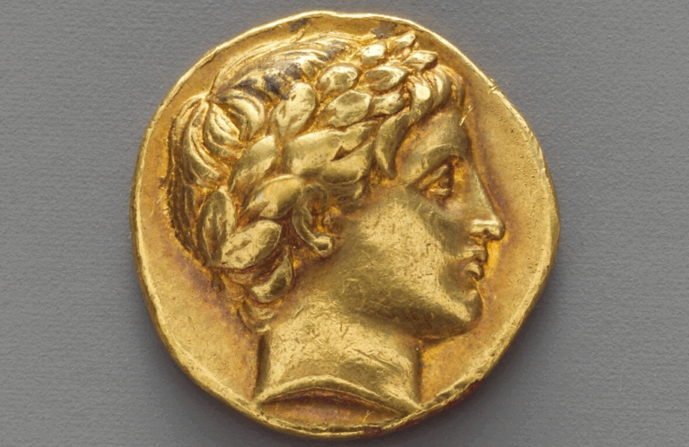 Ancient Greek gold coin (18mm diameter) featuring a laureate bust in high relief, struck during the early Hellenistic period.