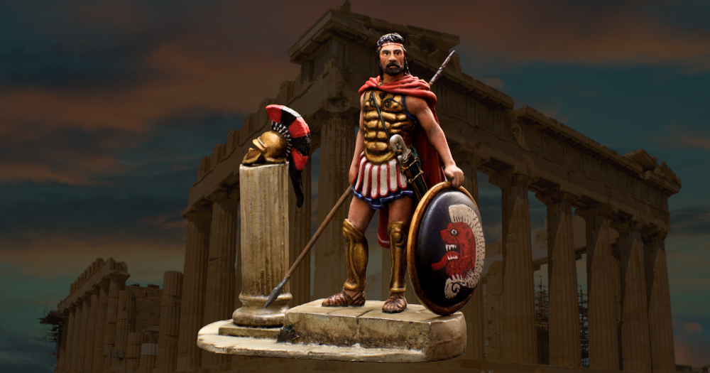 A fully equipped Greek hoplite stands ready for battle, wearing a bronze muscle cuirass and Corinthian helmet, holding a dory spear and aspis shield adorned with a lambda emblem, with bronze greaves protecting his legs.