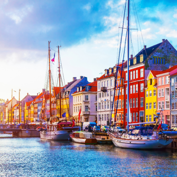 Colorful 17th-century townhouses along Nyhavn’s waterfront in Copenhagen, Denmark. Countries that start with D. 